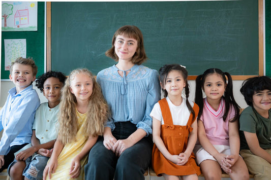 A teacher sitting with students