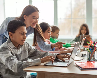 Teacher helping students